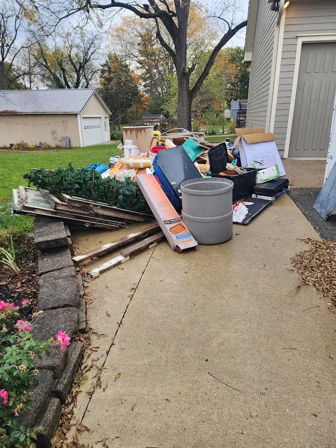 Dumpster being loaded with debris for 12 Yard Dumpster Rental in Townsend